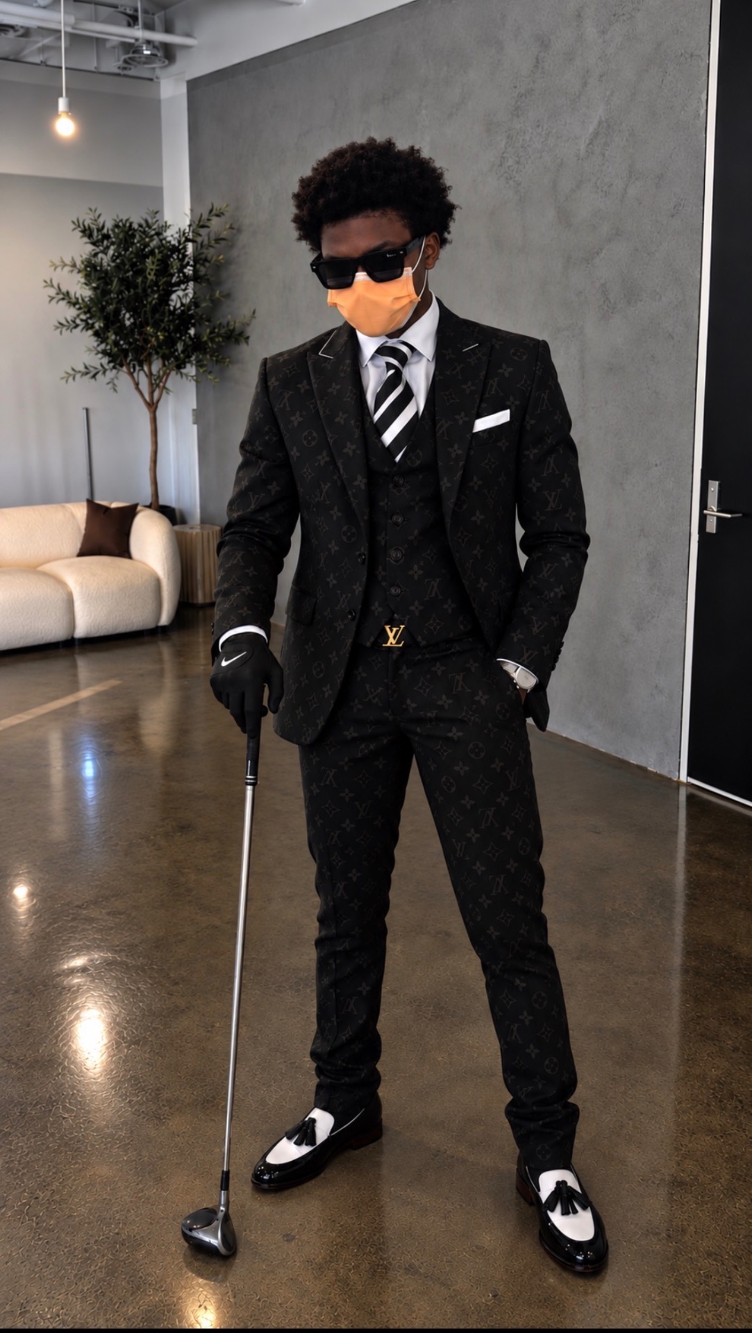 Ashton Clarke in a black suit in a modern living room
